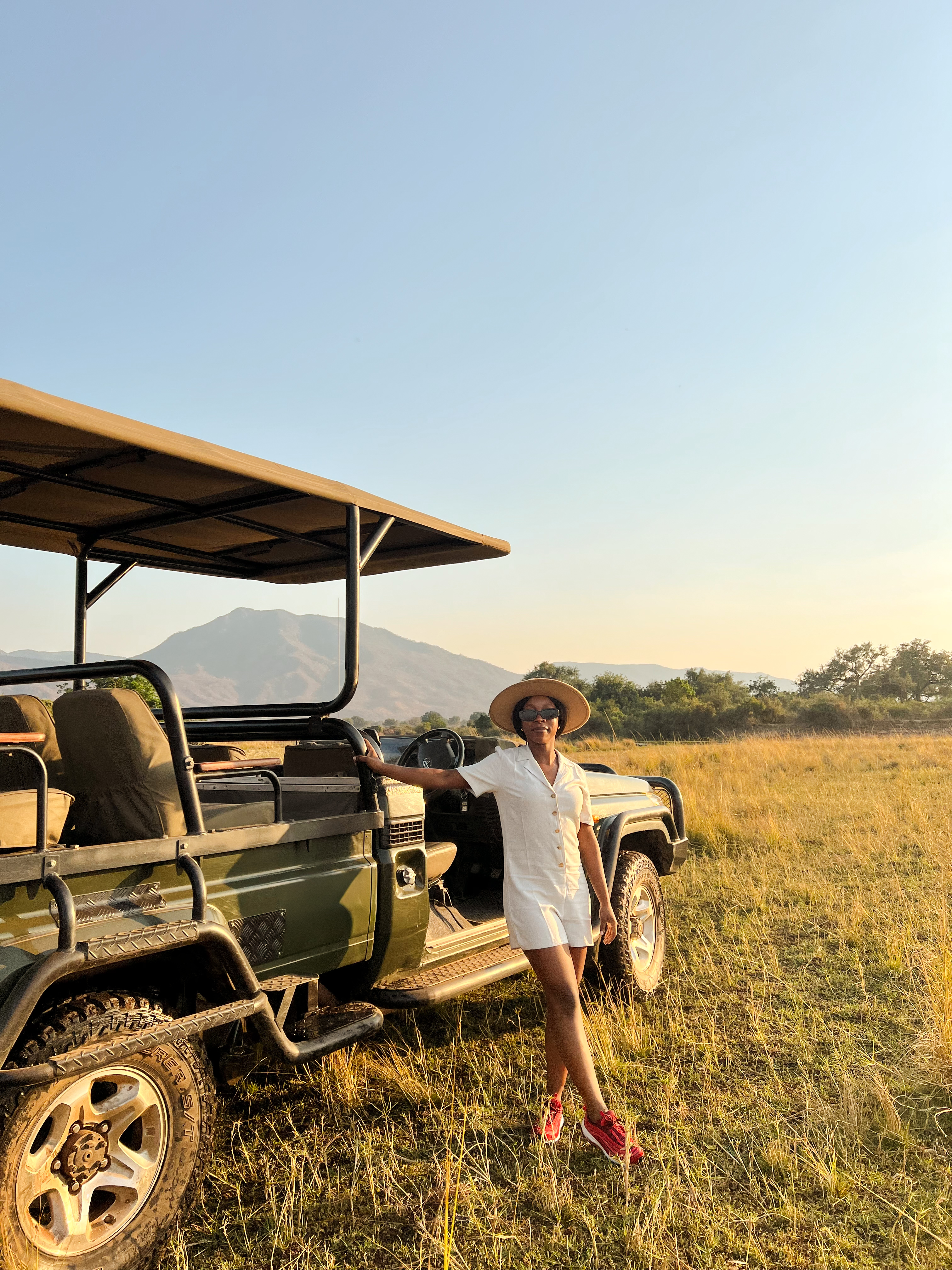 Natascha Muzira, founder of Zuvani Collective, next to a safari vehicle