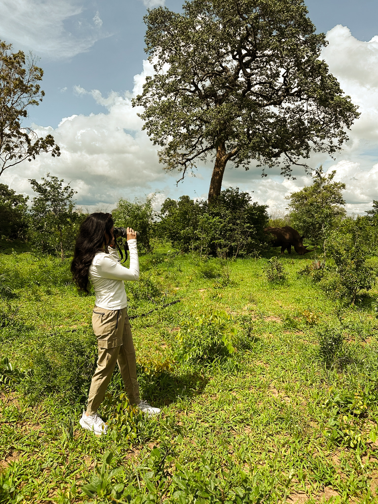A traveller holding up a phone during a guided rhino walk