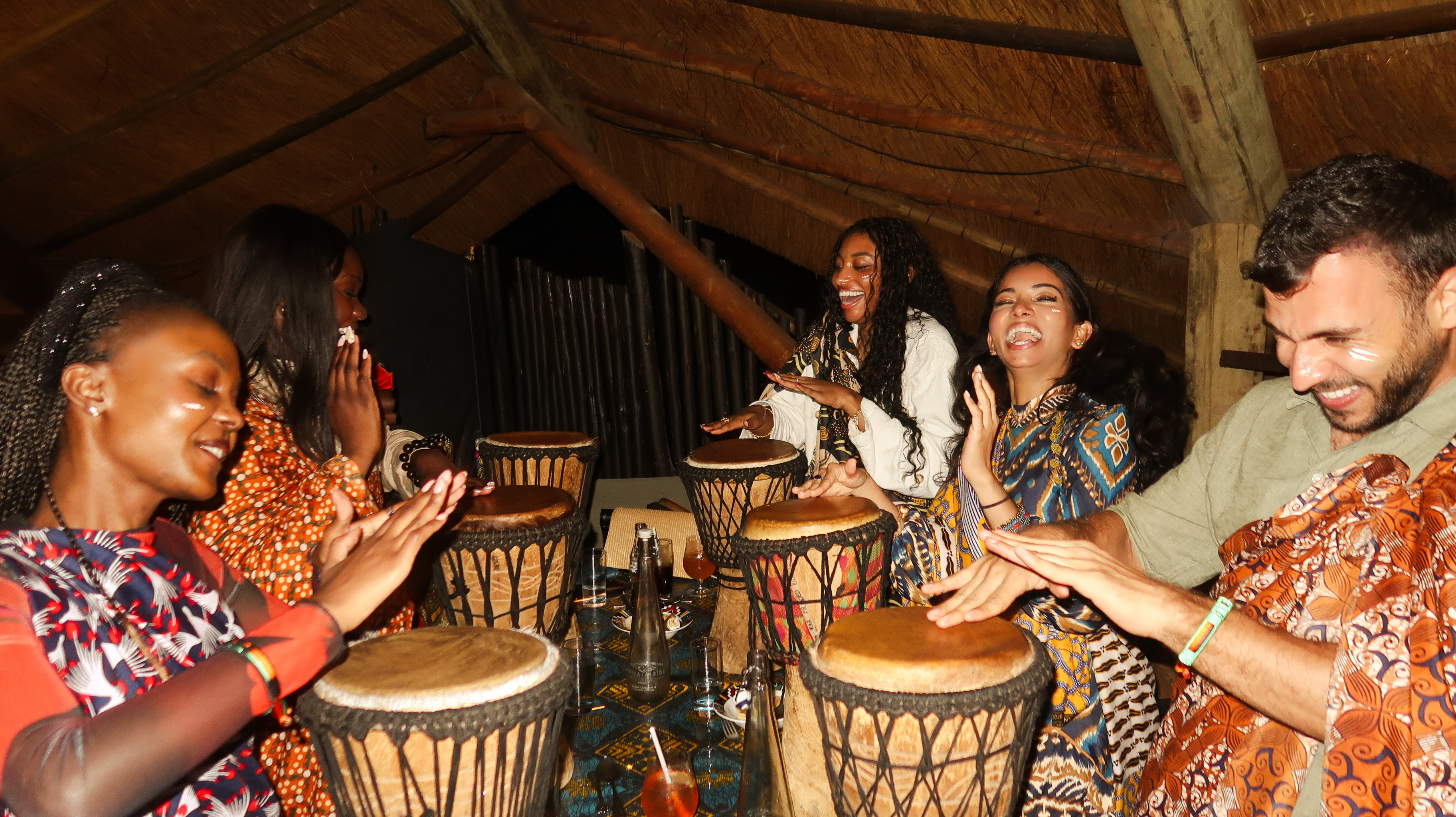 Friends sharing a joyful group drumming experience